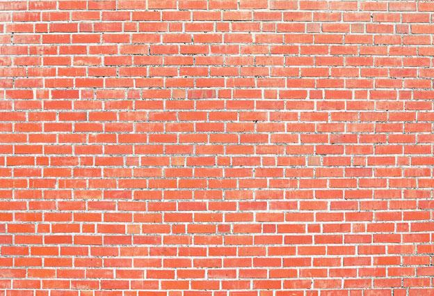 写真のためのkateつのオレンジ色のレンガの古いレトロな壁の背景